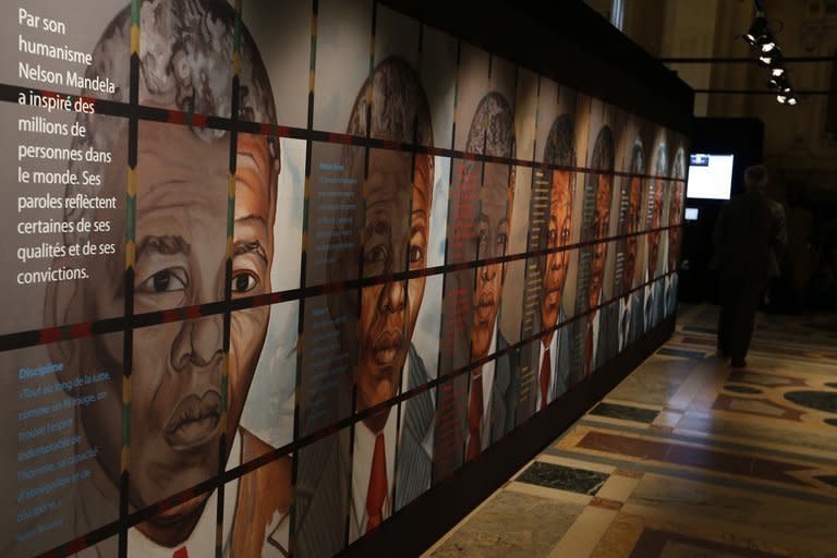 A visitor walks past drawings of Nelson Mandela at the exhibition "Nelson Mandela, from Prisoner to President" in Paris on May 29, 2013. Mandela was in a "serious but stable" condition in hospital on Saturday night with a renewed lung infection that has triggered worldwide concern for the South African hero