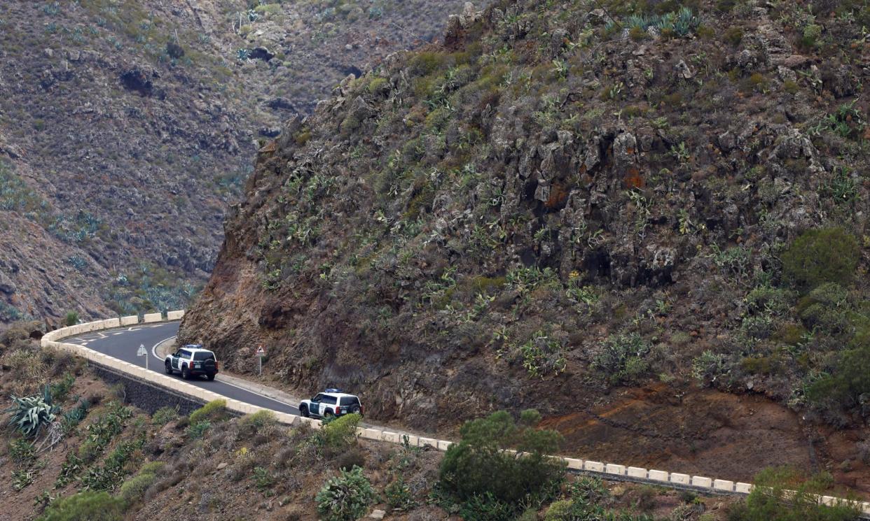 <span>Police look for Jay Slater by the side of a road in the Masca ravine on the island of Tenerife.</span><span>Photograph: Borja Suárez/Reuters</span>