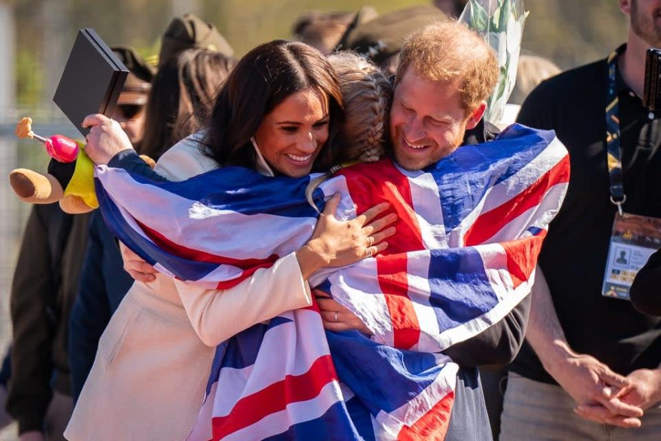 The Duke and Duchess of Sussex hug Team United Kingdom competitor Lisa Johnston (Aaron Chown/PA) (PA Wire)