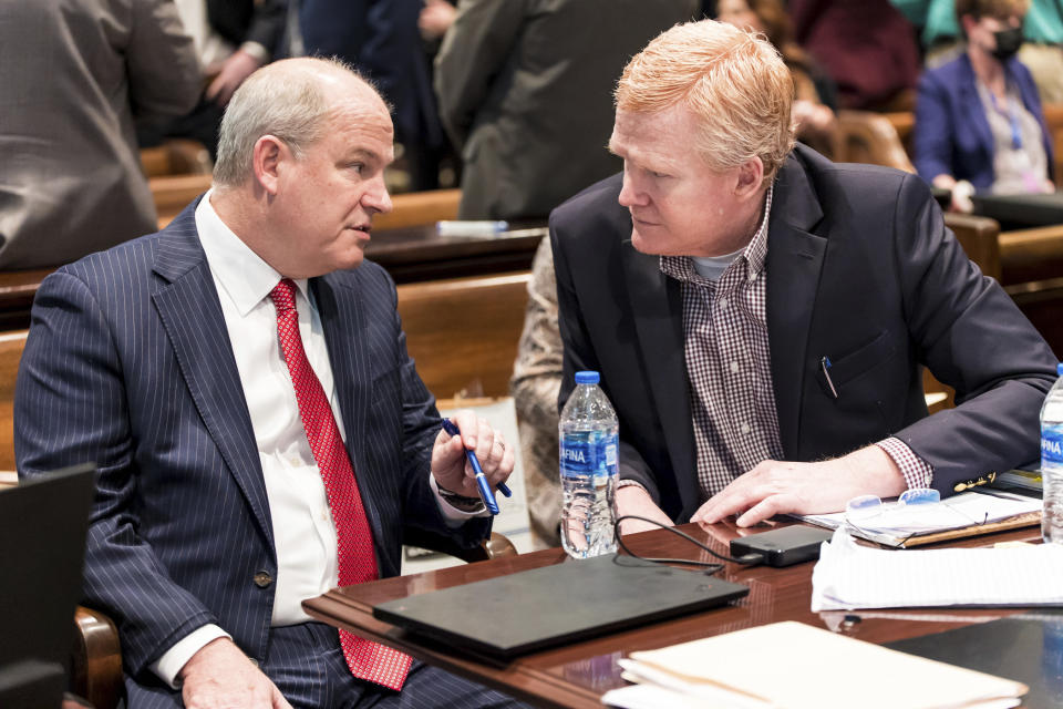 Defense attorney Jim Griffin, left, and Alex Murdaugh speak before the state of Murdaugh's trial at the Colleton County Courthouse in Walterboro, S.C., on Tuesday, Feb. 21, 2023. The 54-year-old attorney is standing trial on two counts of murder in the shootings of his wife and son at their Colleton County, S.C., home and hunting lodge on June 7, 2021. (Jeff Blake/The State via AP, Pool)