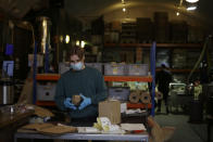 Sam who works in dispatch, processes an online roasted coffee delivery order at the Climpson & Sons roastery in railway arches near Broadway Market in Hackney, east London, Tuesday, Nov. 17, 2020. Small businesses all over the world are struggling to cope as the coronavirus forces changes in consumer habits, but the U.K. also faces uncertainty of the Brexit split from Europe. (AP Photo/Matt Dunham)