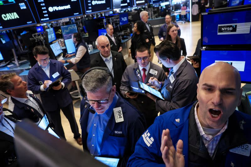 Traders work on the floor of the NYSE in New York