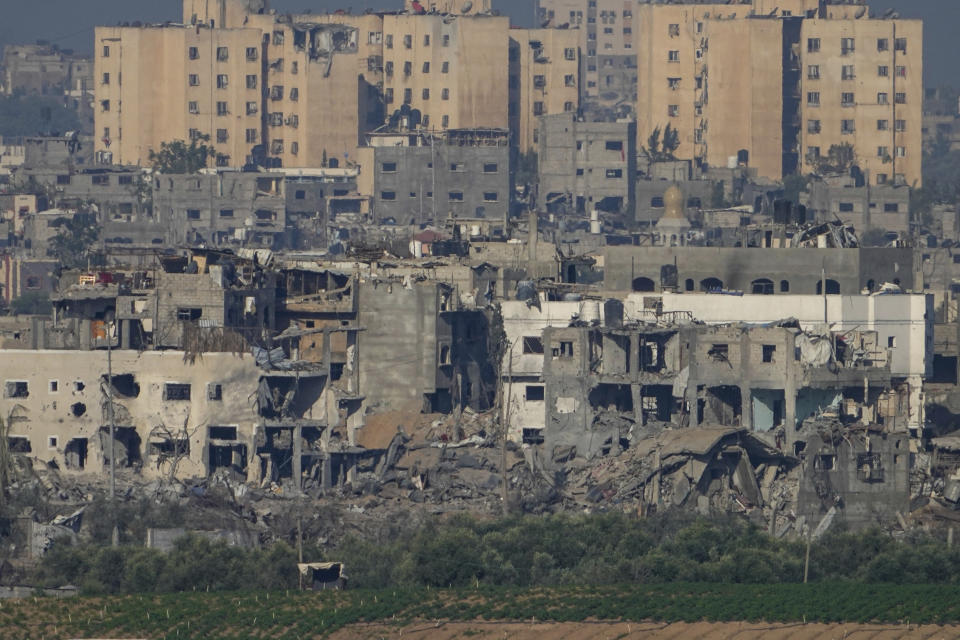 A view of destroyed houses following Israeli strikes in the northern Gaza Strip, as seen from southern Israel, Tuesday, Oct. 17, 2023. Israel has been striking targets throughout Gaza since a bloody, cross-border attack by Hamas militants killed over 1,400 and captured many Israelis on Oct. 7. (AP Photo/Ariel Schalit)