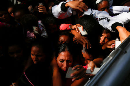 Women queues on the street as they try to buy diapers outside a pharmacy in Caracas, Venezuela March 18, 2017. REUTERS/Carlos Garcia Rawlins