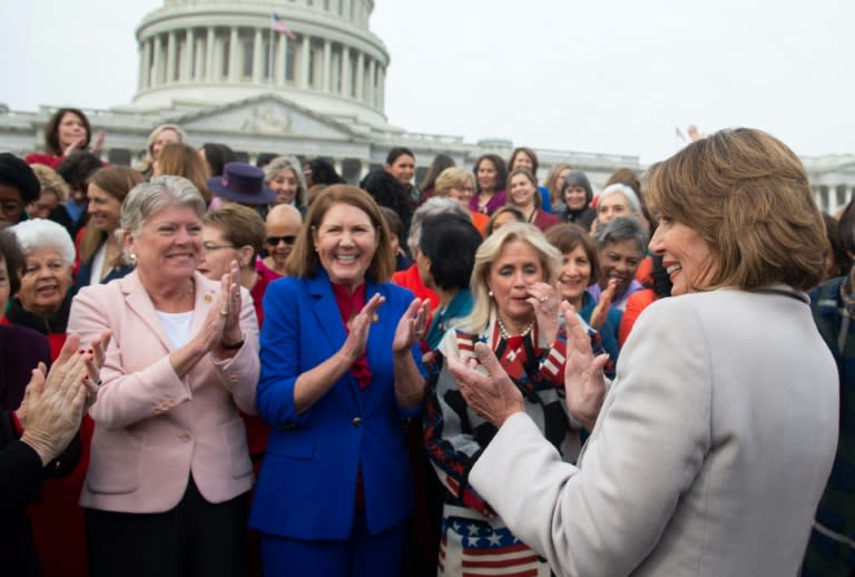 Speaker of the House Nancy Pelosi (R) celebrates with the female House Democratic members of the 116th Congress on January 4, 2018