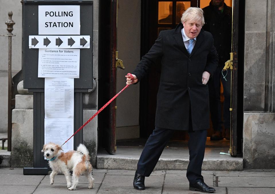 Boris Johnson and his dog Dilyn leave a polling station, after he cast his ballot paper, in 2019AFP/Getty