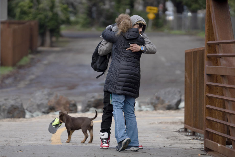 Brett, last name not given, who is homeless, left, is hugged by Beth Perkins, a member of the Resiliency Empowerment Support Team (REST) during a visit to a homeless camp in Chico, Calif., Feb. 8, 2024. A measure aimed at transforming how California spends money on mental health will go before voters in March as the state continues to grapple an unabated homelessness crisis. The REST Program does daily visits to homeless encampments to get them into treatment or housing. Butte County officials fear the REST program would lose it's funding if California voters approve Proposition 1.(AP Photo/Rich Pedroncelli)