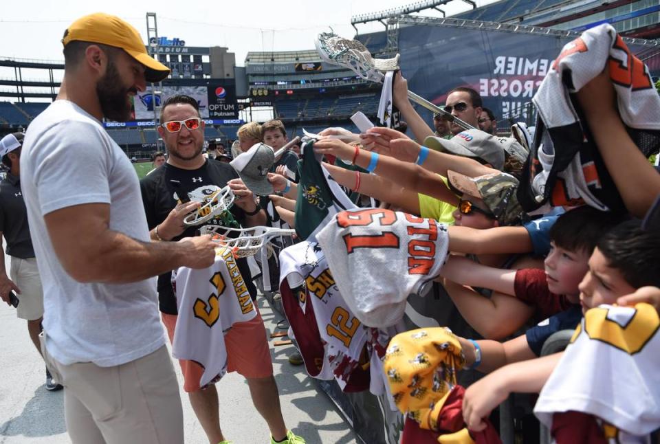 PLL co-founder and former lacrosse player Paul Rabil signs autographs for fans prior to a 2019 match at Gillette Stadium.