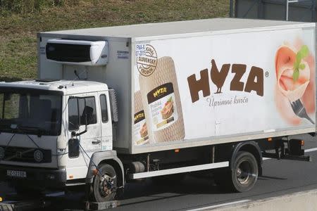 A truck, in which up to 50 migrants were found dead on a motorway near Parndorf, Austria August 27, 2015, is towed away. REUTERS/Heinz-Peter Bader