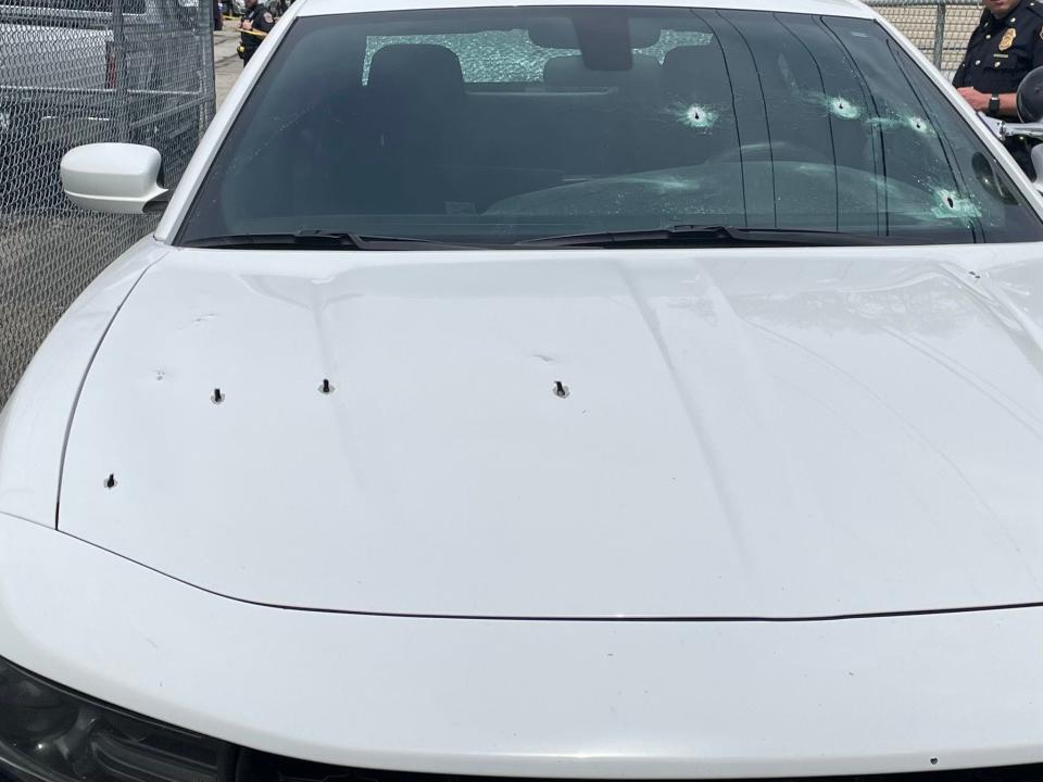 A Indianapolis police vehicle was damaged during a shooting April 20, 2023. The gun used by the suspect sent bullets flying into one of the patrol vehicles at the scene, damaging its hood, grill, side, and both its front and back windshields.