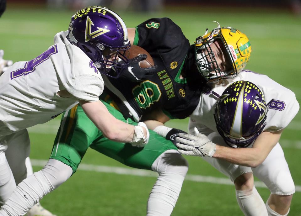 North Kitsap's Benen Lawler (4) and Logan Sloman (8) tackle Lynden's Isaiah Stanley (8) on Saturday, Dec. 3, 2022 in Puyallup.