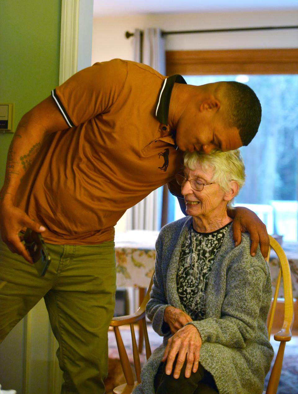 Pedro gives Janet Abbott a kiss and hug on Oct. 1, 2023, and says she is like his American mother. Pedro is one of 48 Venezuelan migrants flown the Martha's Vineyard unexpectedly last year, who is living with Abbott in her Barnstable home.