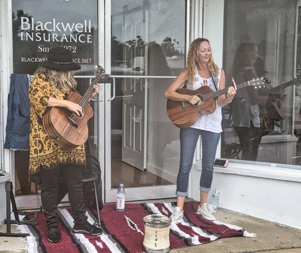 Musicians set out their tip jars to busk in alcoves, under awnings, in store windows and inside shops for Play Music on the Porch Day in Panama City on Aug. 29, 2020.