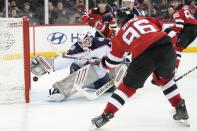 New Jersey Devils right wing Timo Meier (96) scores a goal past Columbus Blue Jackets goaltender Michael Hutchinson during the second period of an NHL hockey game Thursday, April 6, 2023, in Newark, N.J. (AP Photo/Mary Altaffer)