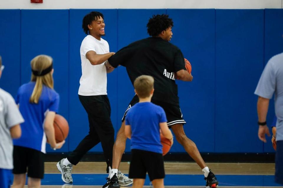 Kentucky’s DJ Wagner, left, jokes around with fellow freshman Jordan Burks during the program’s Father-Son Camp at the Joe Craft Center on June 16.