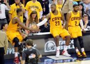 Cleveland Cavaliers center Tristan Thompson (13), forward LeBron James (23) and guard Kyrie Irving (2) wait to reenter the game during the third quarter against the Atlanta Hawks in game four of the Eastern Conference Finals of the NBA Playoffs at Quicken Loans Arena. Mandatory Credit: David Richard-USA TODAY Sports