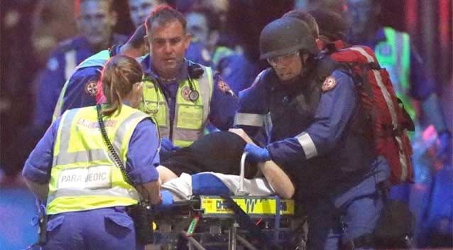 A hostage is taken from the Lindt cafe in Martin Place, Sydney. Photo: Getty