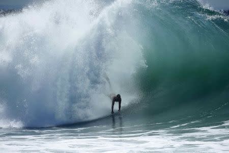 A swimmer catches a wave at "The Wedge" wave break in Newport Beach, California August 27, 2014. REUTERS/Lucy Nicholson