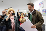 A woman takes a picture as Rafal Trzaskowski, Civic Coalition candidate for mayor of Warsaw, attends the Polish regional elections, at a polling station in Warsaw, Poland, October 21, 2018. Dawid Zuchowicz/Agencja Gazeta via REUTERS