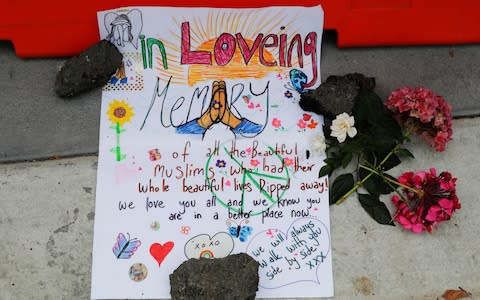 A message is displayed at a makeshift memorial outside Christchurch hospital in Christchurch, New Zealand - Credit: AP