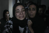 Relatives of two victims who were on a boat carrying migrants from Lebanon that sank in Syrian waters, mourn at their house after they bring back home their dead bodies, in Tripoli, north Lebanon, Sept. 23, 2022. Syria's health minister says several people have been killed from a boat that sank migrants from Lebanon off Syria's coast. The incident is the deadliest since a surging number of Lebanese, Syrians, and Palestinians have tried to flee crisis-hit Lebanon by sea to Europe. (AP Photo/Bilal Hussein)