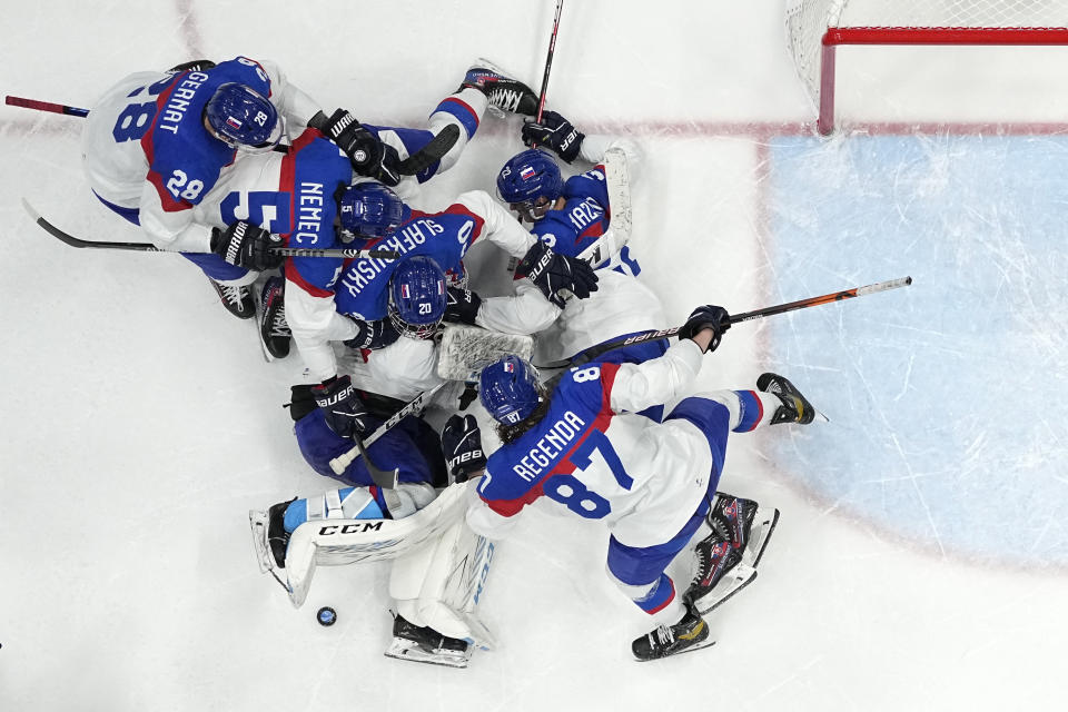 Slovakia players celebrate after beating the United States 3-2 in a shoot-out in a men's quarterfinal hockey game at the 2022 Winter Olympics, Wednesday, Feb. 16, 2022, in Beijing. (AP Photo/Matt Slocum)