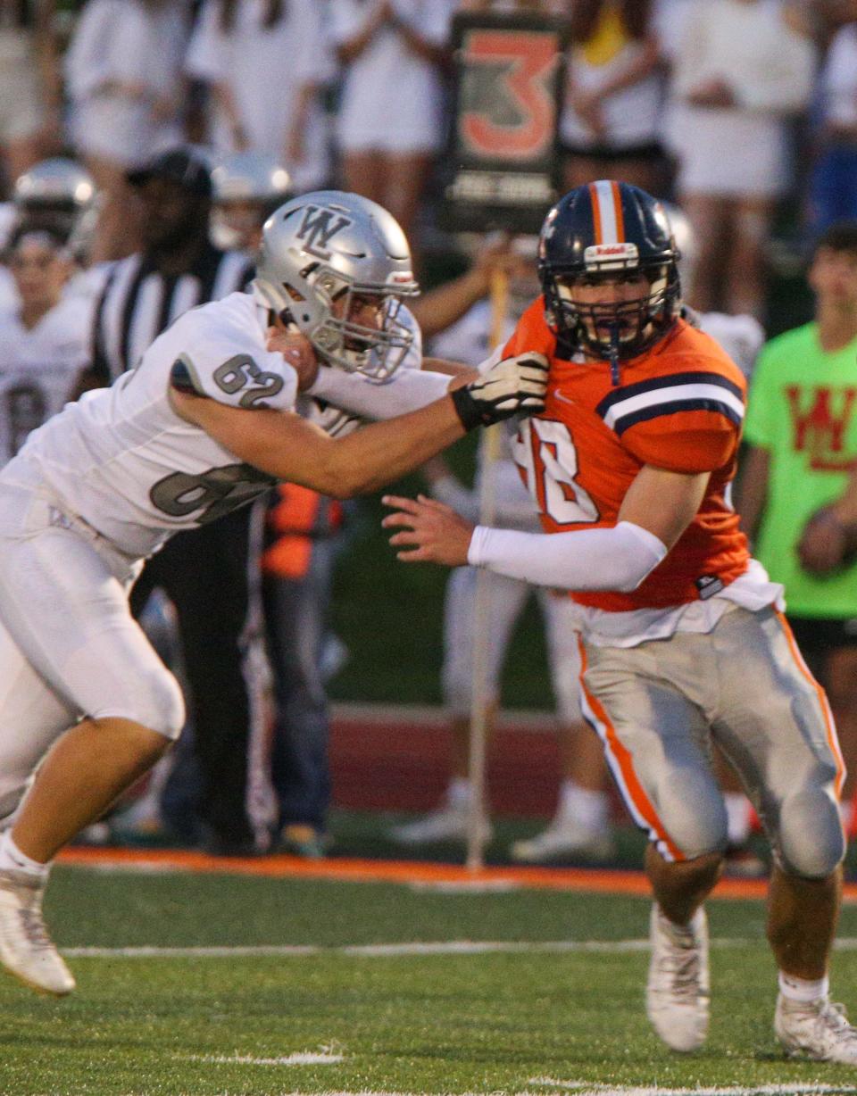 West Lafayette Red Devils defensive lineman Ben Burgett (62) stops Harrison Raiders offensive lineman Jack Johnson (48) from tackling the Red Devils quarterback during the IHSAA football game against the Harrison Raiders, Friday, Aug. 18, 2023, at Harrison High School in West Lafayette, Ind. Harrison won 42 - 6.