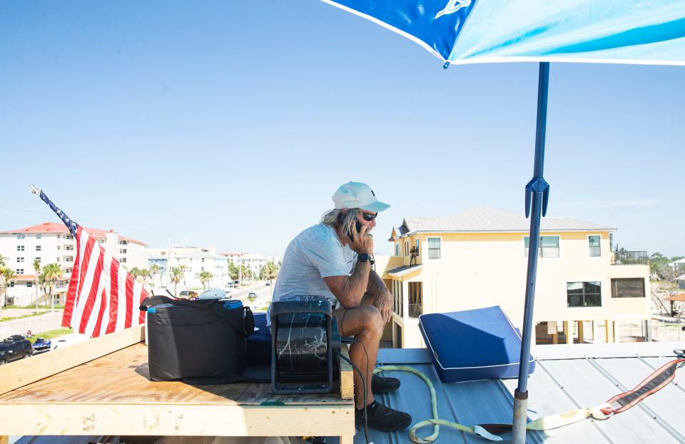 Rick Loughrey battles the hot weather on Monday, August 7, 2023, while continuing to protest from the roof of his Fort Myers Beach garage. He is protesting code regulations that his garage must come into compliance with new FEMA regulations. The entities are still at a stalemate.