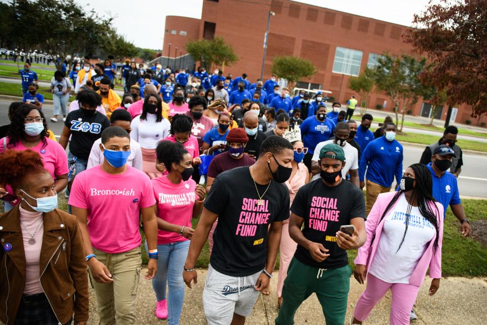 NBA players Dennis Smith Jr. and Chris Paul lead Fayetteville State students over to Smith Recreation Center to vote on Wednesday, Oct. 28, 2020. Paul is traveling the country going to historically black colleges to get people to vote in the upcoming election.