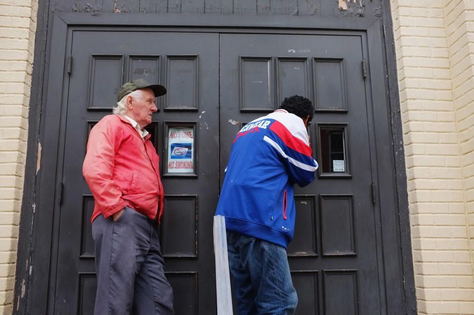 READING, PA - OCTOBER 20: Men look in the window of the Central Park United Methodist Church which has a soup kitchen and food pantry on October 20, 2011 in Reading, Pennsylvania. The church feeds thousands of needy Reading residents monthly and relies on donations and volunteers to keep its increasingly popular programs operating. Reading, a city that once boasted numerous industries and the nation's largest railroad company, has recently been named America's poorest city with residents over 65,000. According to new census data, 41.3 percent of people live below the poverty line in Reading. Reading has about 90,000 residents, many of whom are recent Hispanic arrivals who have moved from larger eastern cities over the past decade. While a manufacturing base offering well paying jobs still exists in Reading, many companies like Hershey, Stanley Tool and Dana Systems have either moved elsewhere in the United States or to Mexico in search of cheaper labor. The number of people living in poverty in America, 46.2 million, is now at its highest level for the 52 years the Census Bureau has been keeping records. (Photo by Spencer Platt/Getty Images)