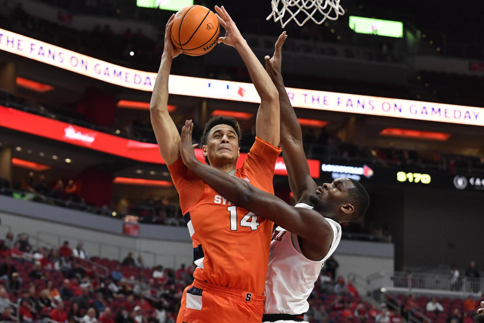 Syracuse center Jesse Edwards (14) puts a shot up over Louisville forward Brandon Huntley-Hatfield (5) during the first half of an NCAA college basketball game in Louisville, Ky., Tuesday, Jan. 3, 2023. (AP Photo/Timothy D. Easley)