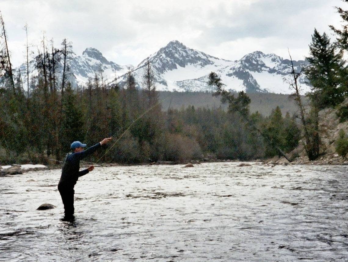 In this 2006 file photo, an angler casts for steelhead on the Upper Salmon River in the shadow of the Sawtooth Mountains. 