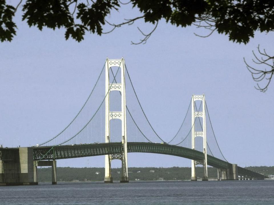  This file photo shows the Mackinac Bridge that spans the Straits of Mackinac from Mackinaw City, Mich. Michigan regulators have approved a $500 million plan by Enbridge to encase a portion of an oil pipeline that runs beneath a channel connecting two Great Lakes.