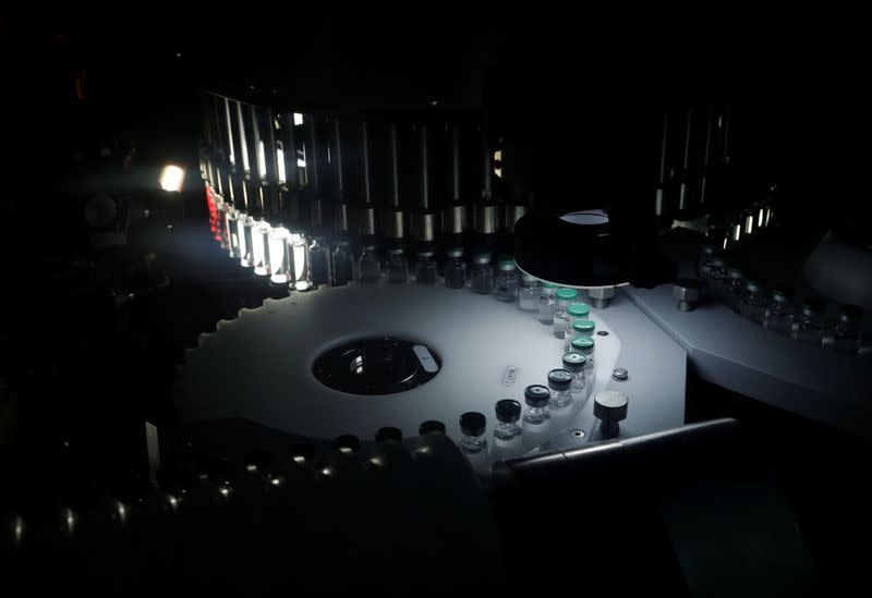 Vials of AstraZeneca's COVISHIELD, coronavirus disease (COVID-19) vaccine are seen inside a visual inspection machine inside a lab at the Serum Institute of India, Pune