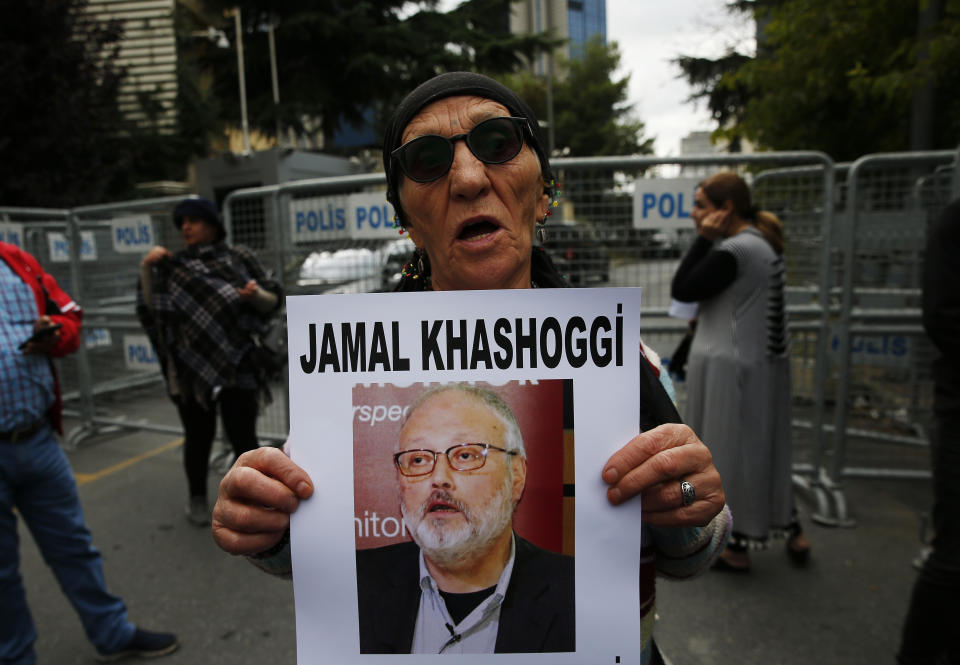 An activist, member of the Human Rights Association Istanbul branch, holds a poster with a photo of missing Saudi journalist Jamal Khashoggi, during a protest in his support near the Saudi Arabia consulate in Istanbul, Tuesday, Oct. 9, 2018. Turkey said Tuesday it will search the Saudi Consulate in Istanbul as part of an investigation into the disappearance of a missing Saudi contributor to The Washington Post, a week after he vanished during a visit there. (AP Photo/Lefteris Pitarakis)