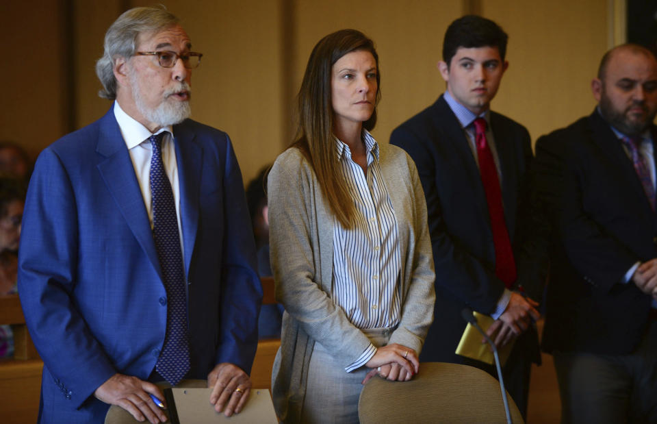 Michelle Troconis, center, listens as a member of her legal team Andrew Bowman, left, addresses the court during a hearing at Stamford Superior Court, Tuesday, June 11, 2019 in Stamford, Conn. Fotis Dulos, and his girlfriend, Michelle Troconis, have been charged with evidence tampering and hindering prosecution in the disappearance of his wife Jennifer Dulos. The mother of five has has been missing since May 24. (Erik Trautmann/Hearst Connecticut Media via AP, Pool)