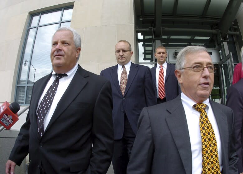 FILE - In this Tuesday, Sept., 15, 2009, file photo, former Luzerne County Court Judges Michael Conahan, front left, and Mark Ciavarella, front right, leave the United States District Courthouse in Scranton, Pa. The two Pennsylvania judges who orchestrated a scheme to send children to for-profit jails in exchange for kickbacks were ordered to pay more than $200 million to hundreds of children who fell victim to their crimes. U.S. District Judge Judge Christopher Conner awarded $106 million in compensatory damages and $100 million in punitive damages to nearly 300 plaintiffs in a long-running civil suit against the judges.(Mark Moran/The Citizens' Voice via AP)