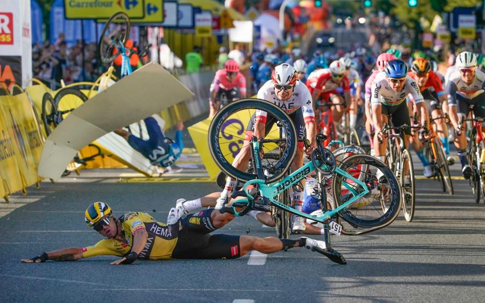 Dutch cyclist Dylan Groenewegen crashes to the ground as a bicycle is flying overhead in a major collision on the final stretch of the opening stage of the Tour de Pologne race - Fabio Jakobsen in an induced coma after a horrific crash during Tour of Poland first stage - AP