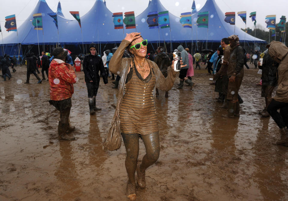 A girl is seen soaked in mud at the Isle of Wight Festival after torrential downpours last weekend.