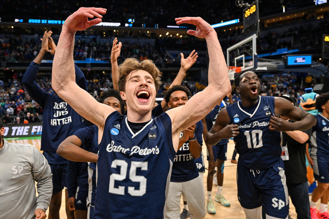 INDIANAPOLIS, IN - MARCH 17: Doug Edert #25 of the St. Peter's Peacocks and his teammates celebrate after defeating the Kentucky Wildcats in the first round of the 2022 NCAA Men's Basketball Tournament held at Gainbridge Fieldhouse on March 17, 2022 in Indianapolis, Indiana. St. Peter's Peacocks won in overtime, 85-79. (Photo by Jamie Sabau/NCAA Photos via Getty Images)
