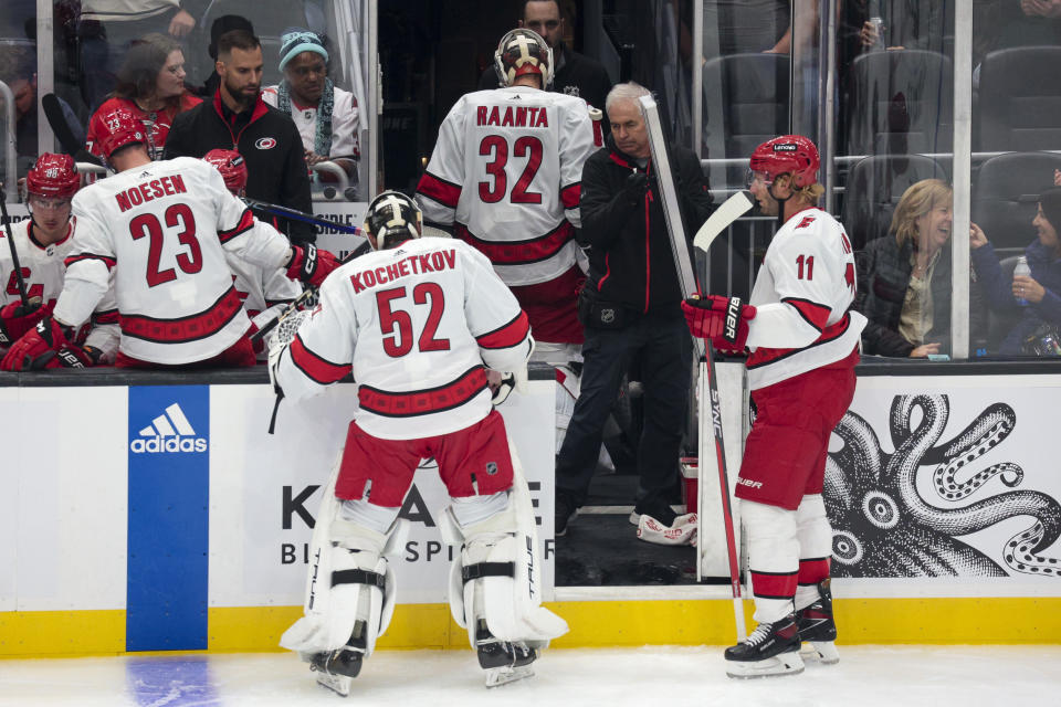 Carolina Hurricanes goaltender Pyotr Kochetkov (52) replaces goaltender Antti Raanta (32) during the second period of an NHL hockey game against the Seattle Kraken, Thursday, Oct. 19, 2023, in Seattle. (AP Photo/Jason Redmond)