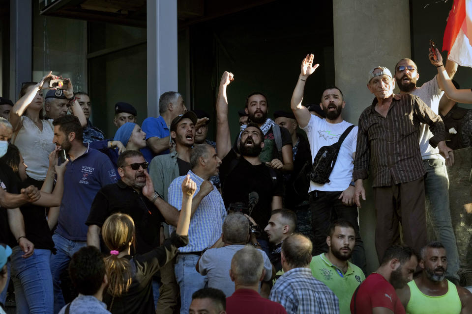 Protesters chant slogans during a demonstration against a recent hike in the prices of telecommunication and internet services, outside the building of MTC Touch, one of the country's two state-contracted telecom companies, in Beirut, Lebanon, Tuesday, July 5, 2022. Lebanon has been reeling from an economic crisis that has pulled over three quarters of its population into poverty in less than three years. (AP Photo/Bilal Hussein)