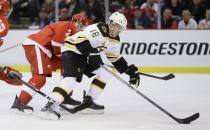 Boston Bruins right wing Reilly Smith (18) controls the puck ahead of Detroit Red Wings defenseman Brendan Smith during the first period of Game 4 of a first-round NHL hockey playoff series in Detroit, Thursday, April 24, 2014. (AP Photo/Carlos Osorio)