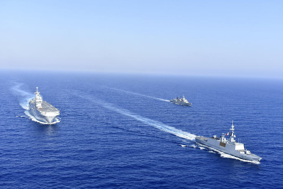 In this photo provided by the Greek National Defence, a French Tonnerre helicopter carrier is escorted by Greek and French military vessels during a maritime exercise in the Eastern Mediterranean, Thursday, Aug. 13, 2020. Greece's prime minister warmly thanked France Thursday for its decision to boost its military presence in the eastern Mediterranean, where Greek and Turkish warships are closely shadowing each other over a Turkish energy exploration bid in waters Athens claims as its own. (Greek National Defence via AP)