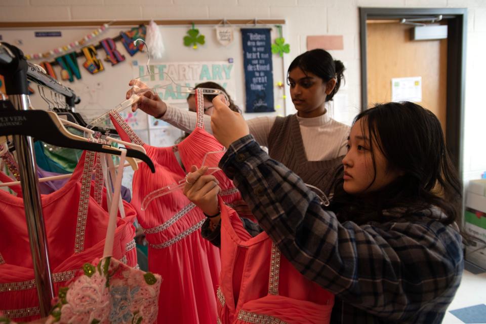 Bensalem senior class officer Madison Thai puts a donated prom gown back on the rack in a classroom at Bensalem High School on Tuesday, March 14, 2023. The school has put together a closet of prom gown donations for students to choose from for their upcoming senior prom on April 21.