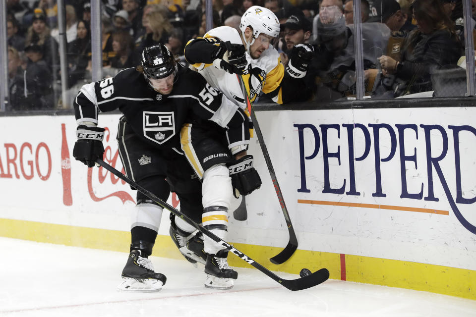 Los Angeles Kings' Kurtis MacDermid (56) collides with Pittsburgh Penguins' Brandon Tanev during the first period of an NHL hockey game Wednesday, Feb. 26, 2020, in Los Angeles. (AP Photo/Marcio Jose Sanchez)