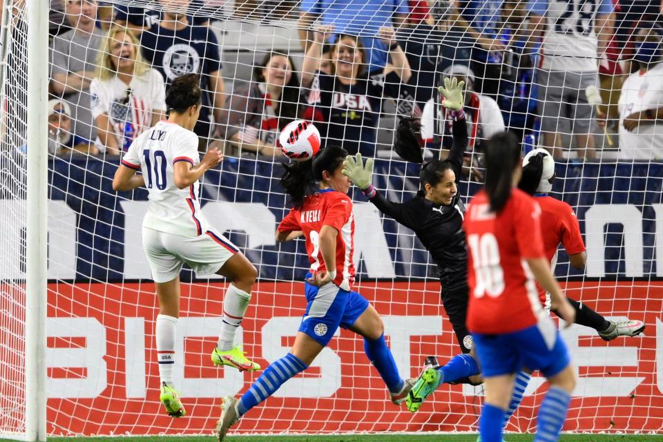 Carli Lloyd scores a goal against Paraguay.