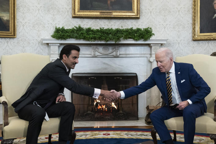 President Joe Biden, right, shakes hands with the Qatar's Emir Sheikh Tamim bin Hamad Al Thani in the Oval Office of the White House, Monday, Jan. 31, 2022, in Washington. (AP Photo/Alex Brandon)
