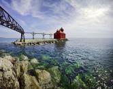 <p>The vivid red Sturgeon Bay Lighthouse really stands out on the blue water in Door County, Wisconsin.</p>