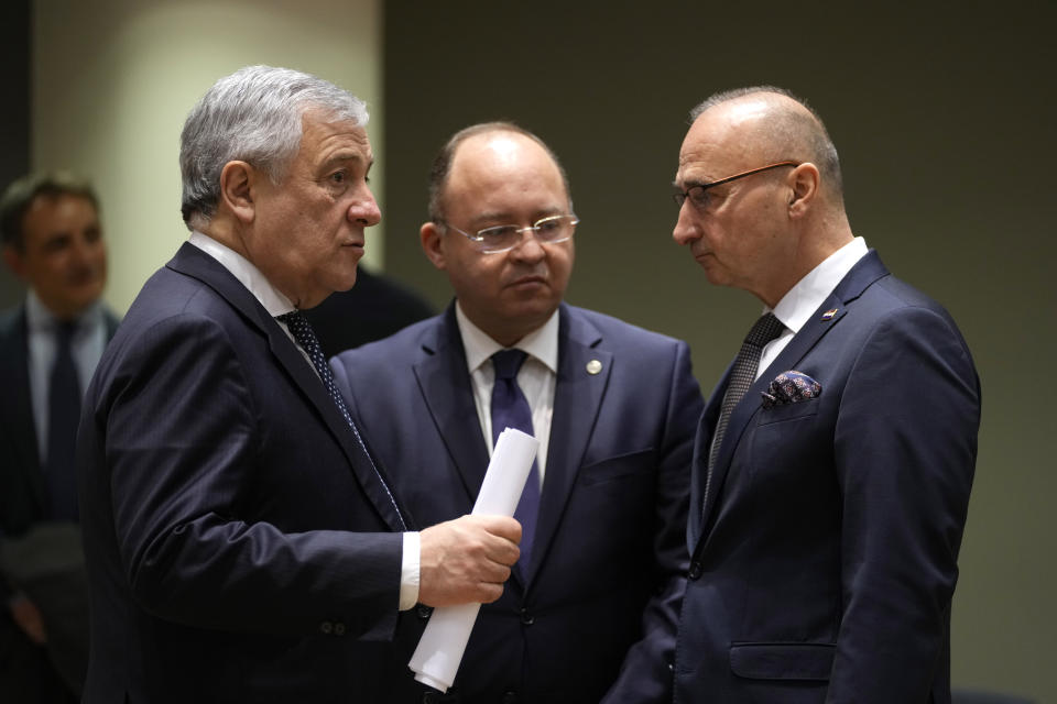 Italy's Foreign Minister Antonio Tajani, left, speaks with Croatia's Foreign Minister Gordan Grlic Radman, right, and Romania's Foreign Minister Bogdan Aurescu during a meeting of EU foreign ministers at the European Council building in Brussels on Monday, Jan. 23, 2023. EU foreign ministers are meeting to discuss support for Ukraine, including more money to help buy weapons, and the crackdown on demonstrators in Iran. (AP Photo/Virginia Mayo)
